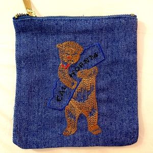 Spitfire Girl embroidered denim pouch.